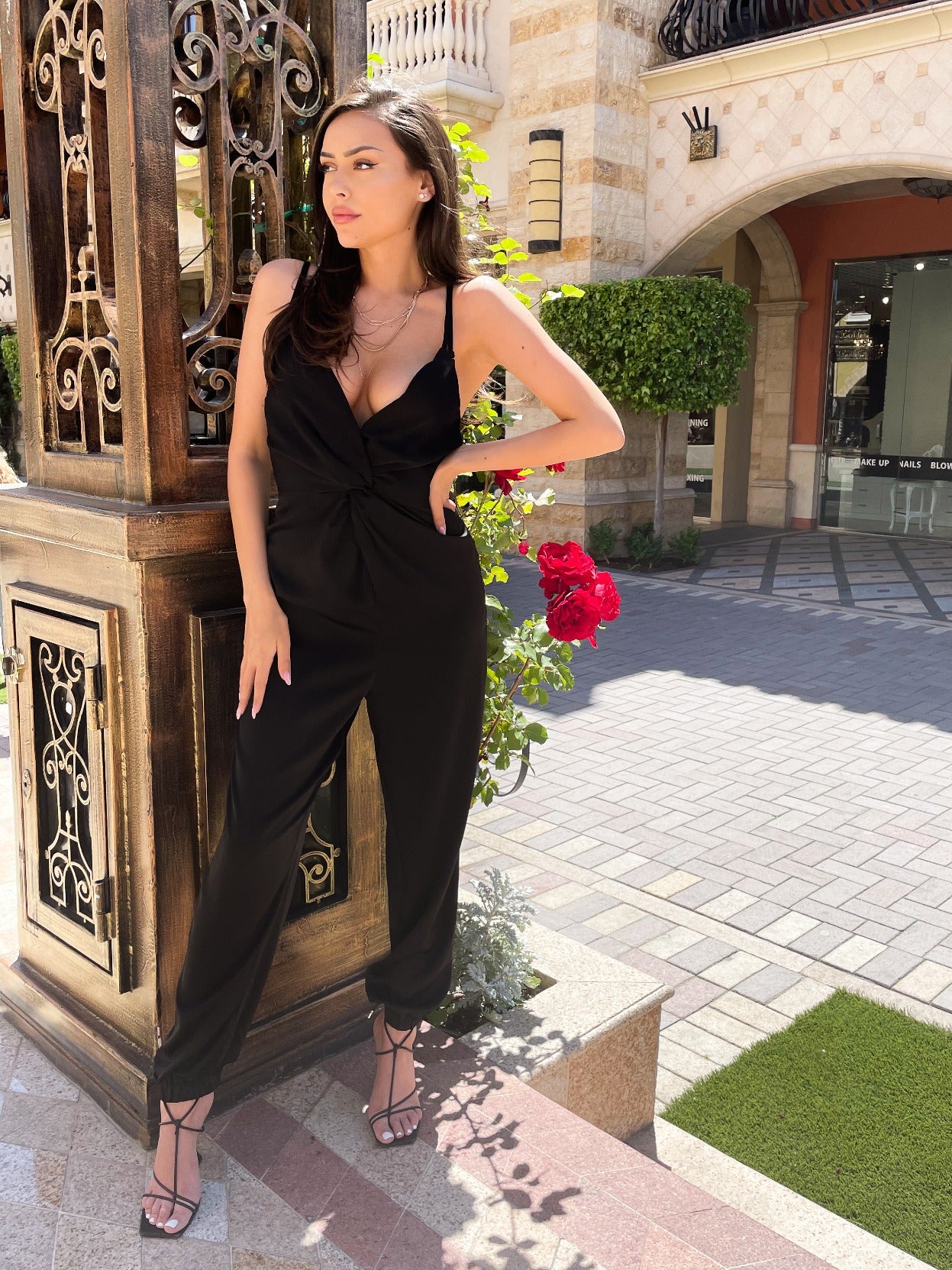 Silky Black Jumpsuit perfect fo beach clubs, date night, events, and girls night out. Twist front detail with cuffed pant bottoms. 